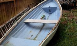 Fibreglass rowboat comes with a mast, sails and wheels for transport.