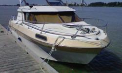 22 foot cabin cruiser boat is loaded and ready for fishing or long trips. In nice shape, runs great. Has an enclosed rest room with head and light shower, plus private sleeping area (sleeps 4). Galley has double burner alcohol stove, sink, and ice box.