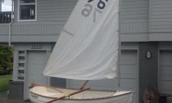 8 ft Fiberglass Clinker/Lapstrake Rowing/Sailing Dinghy made by Hawthorne in La Conner Washington. Front and rear cast in ballast tanks so it can't be sunk. 12' aluminum mast with sail, built in drop keel, removable rudder and oars, unfortunately missing