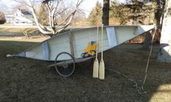 16 ft fiberglass canoe with paddles and new lifejacket also two wheel cart for moving