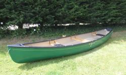 Beautiful little flat back canoe - perfect for solo or tandem fishing. Transom back for optional electric or 3HP motor. Canoe is 14.5' long, 38" wide, weighs 69 lbs. Made of durable, resilient Royalex (used in whitewater canoes). Three seats - wood/web in