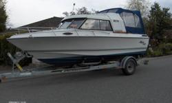 1990 Malibu 202.  Cuddy, through hull toilet, captain's chairs.  Has slope-back canvas as well as stand-up canvas.  Swim grid, compass, depth sounder.
 
250 ci Volvo Penta with a 290 leg.  Engine serviced summer 2011.
 
1993 EZE Loader trailer with new
