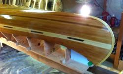 15 ft canoe, red cedar, yellow cedar, and dark walnut. Outside,6 oz cloth, three coats west system clear epoxy, and 4 coats spar varnish. Inside 6 oz cloth, three coats west system clear epoxy,3 coats spar varnish. Seats yellow cedar with real cane weave