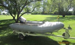 Zodiak 11.5 ft, 30 hp Nissan outboard motor with front steering and throttle controls.  Comes with trailer. Good condition.